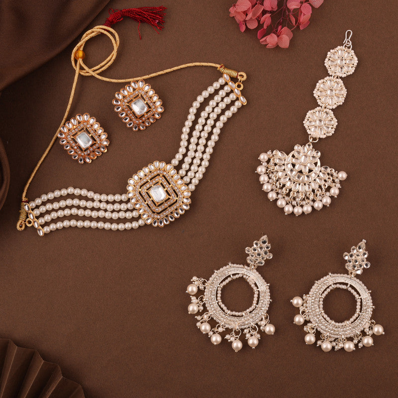 Gold-toned Kundan and pearl necklace set with matching earrings and tikka