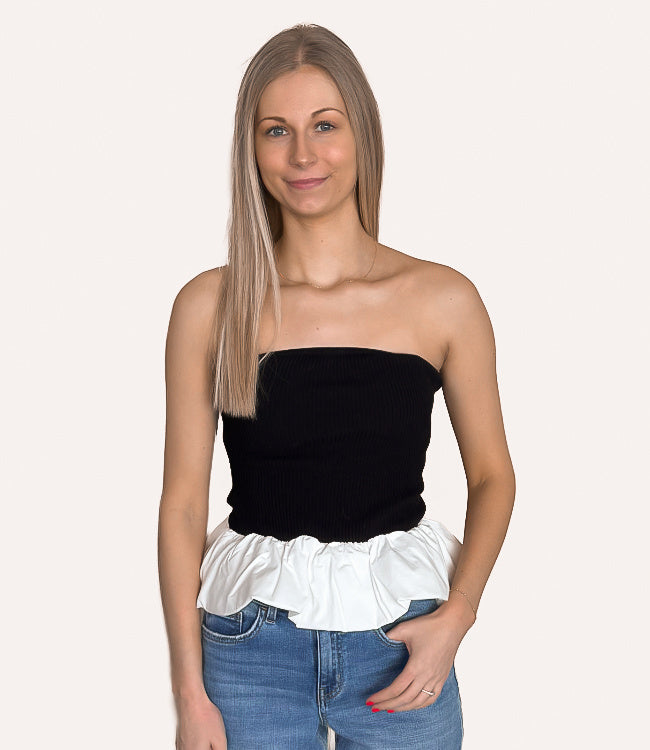 Black ribbed knit tube top featuring a voluminous bubble peplum hem and a fitted bodice.