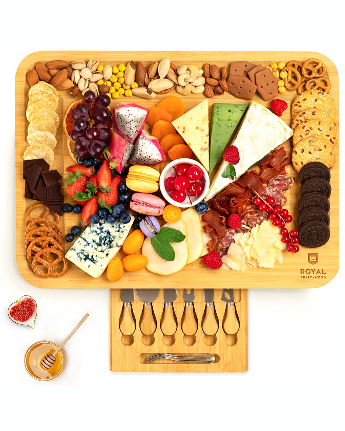 XXL bamboo cheese board with slide-out drawer containing stainless steel cheese knives and forks, displayed with various foods.