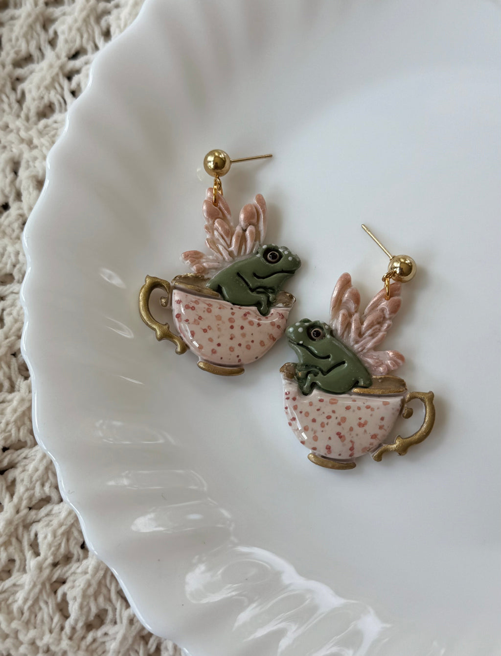 Close up of artisan Teacup Frog Earrings in Ivory with 14k gold hardware
