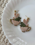Close up of artisan Teacup Frog Earrings in Ivory with 14k gold hardware