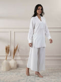 Woman wearing a white V-neck cotton top paired with matching flared trousers