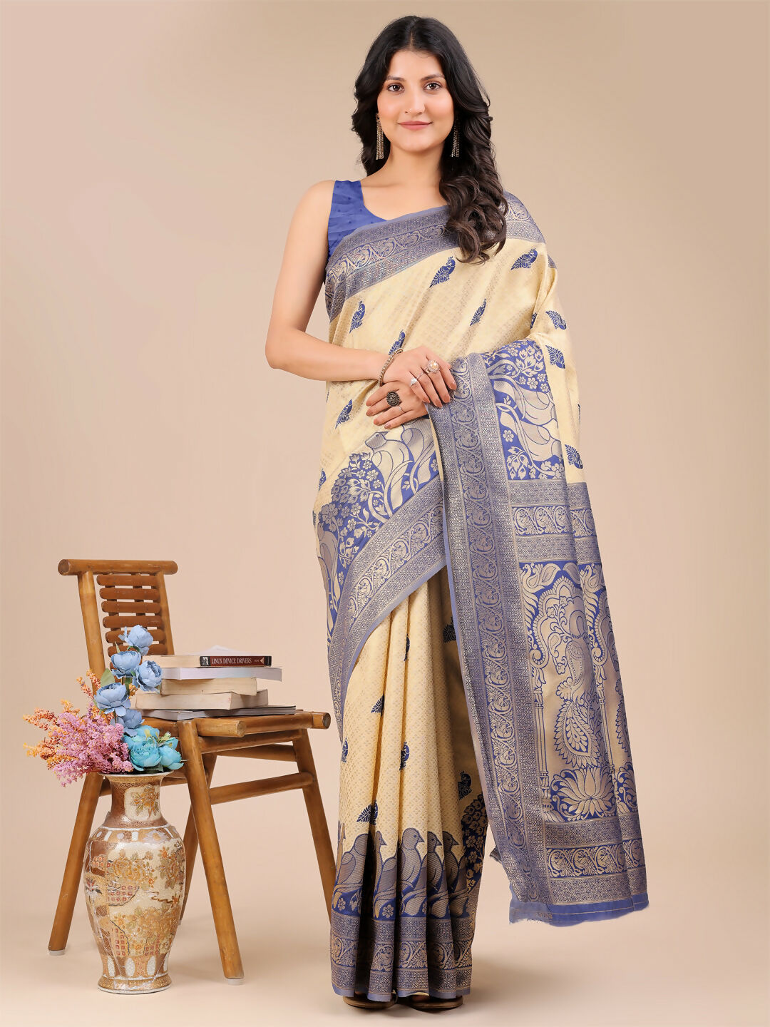 Woman wearing a luxurious cream and navy blue Banarasi silk saree with a matching blouse.