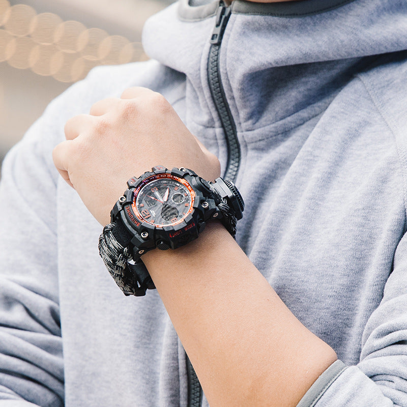 Stevvex 6-in-1 survival sports watch with paracord strap, compass, and digital display for outdoor adventure.