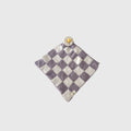 Grape Soda lovey made of microfiber feather yarn featuring a modern geometric knit pattern in grape purple and white.