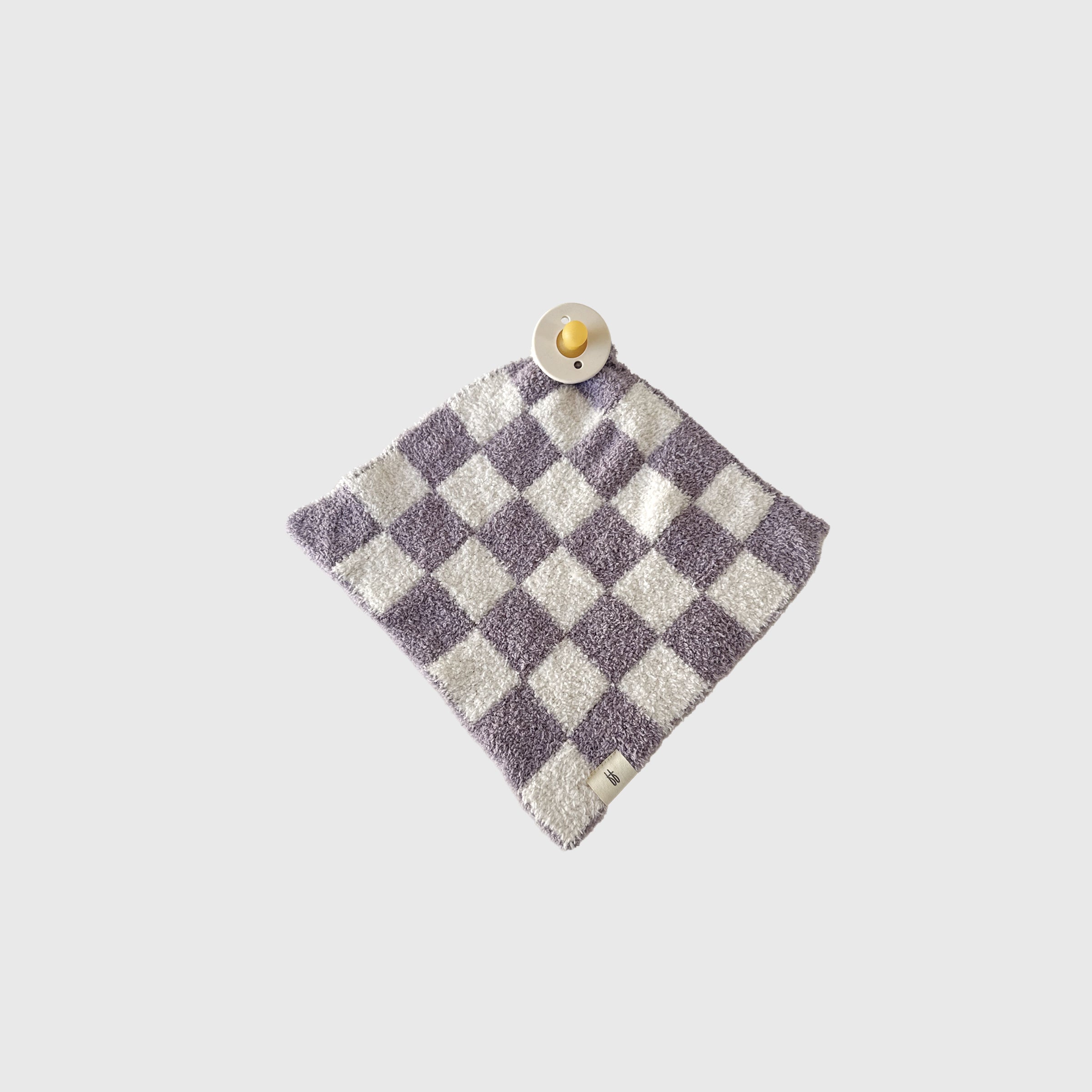 Grape Soda lovey made of microfiber feather yarn featuring a modern geometric knit pattern in grape purple and white.