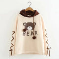 Woman wearing a cute bear ear hoodie with ribbon details and long sleeves