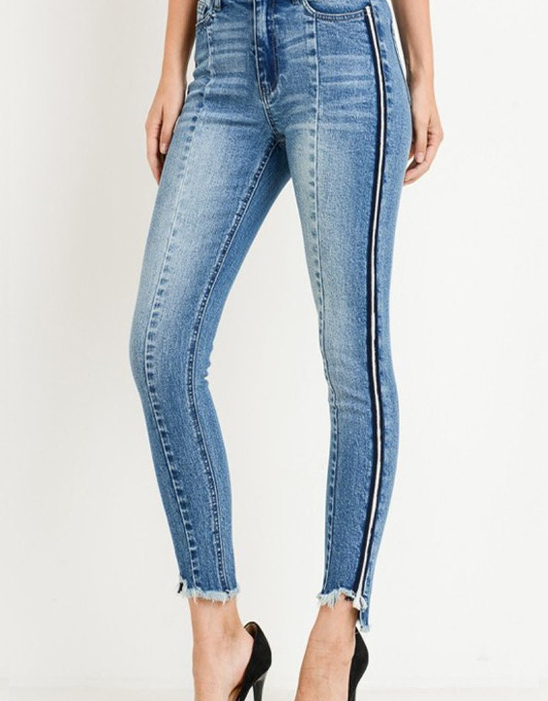 High waist skinny jeans featuring side color tape detail worn by a model