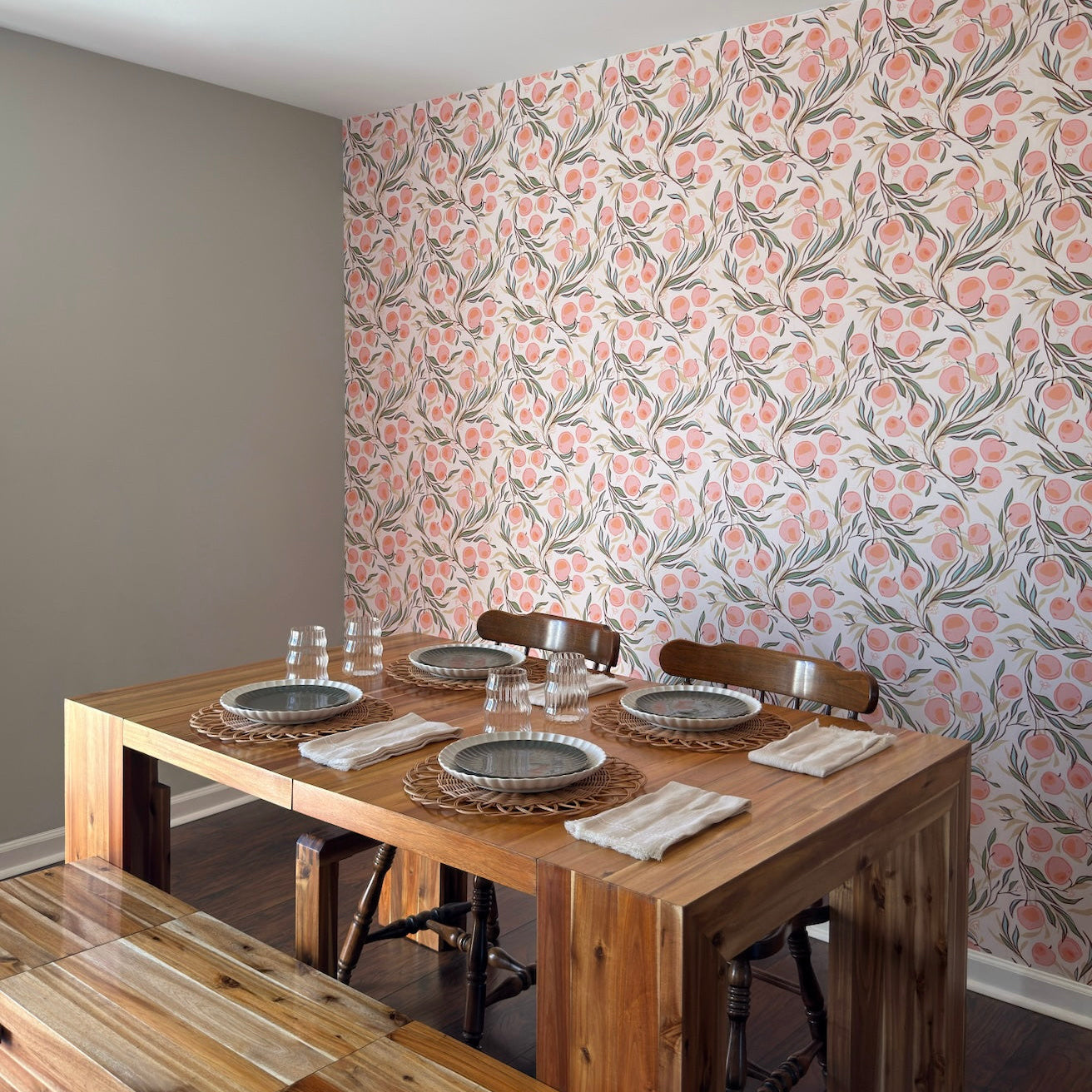 Close up of Paige floral botanical wallpaper featuring peach, sage-green, and dark-charcoal patterns.
