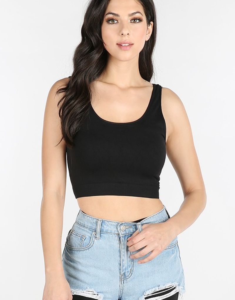 A woman wearing a minimalist solid-colored knit crop top in a versatile athleisure style.
