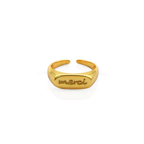 Close-up of a gold "Merci" engraved adjustable ring with a polished finish, showcased on a white background and in a soft-lit lifestyle setting.