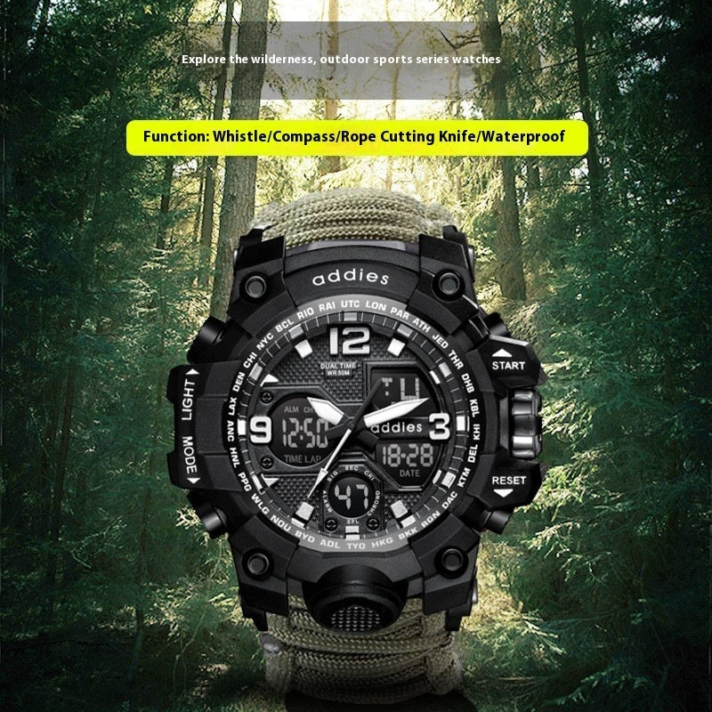 Military survival watch with integrated compass, whistle, and paracord strap on a wrist.