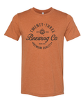 Close up of a rust-colored Twenty-Three Brewing Co. unisex graphic t-shirt.