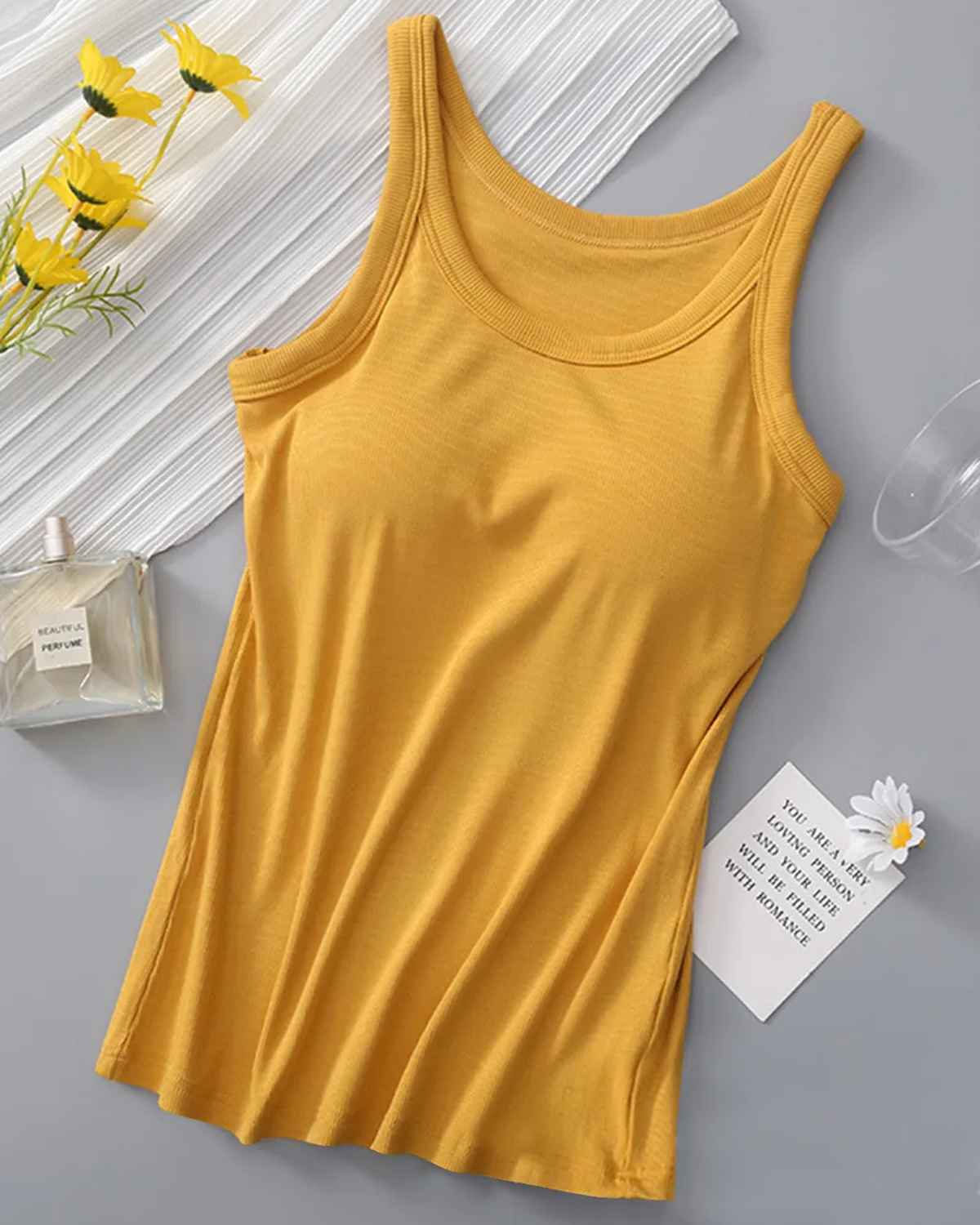 Round neck athleisure tank top with integrated bra in a solid color.