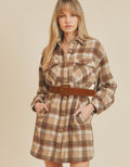 Woman wearing a beige and brown Benny plaid shirt dress in a casual preppy style