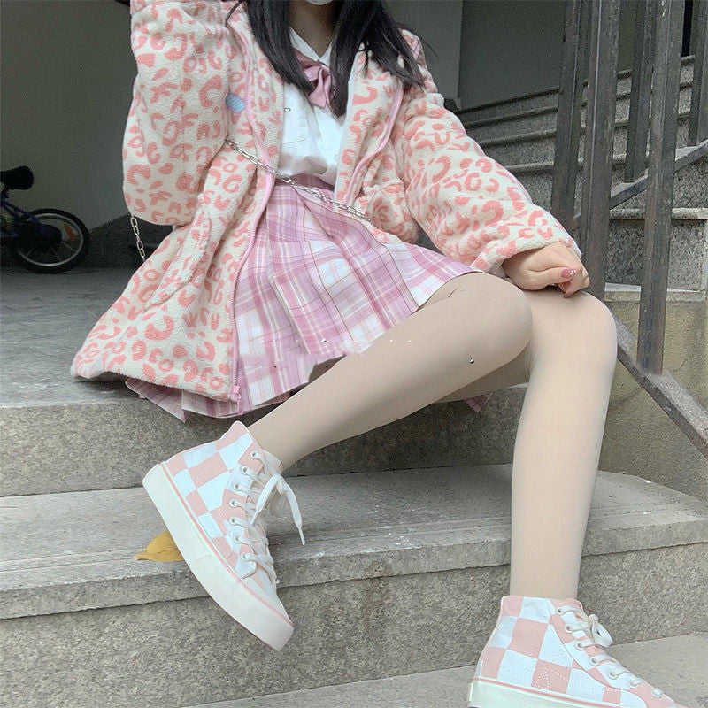A pair of pink high-top canvas sneakers for women with a slip-on design and durable PU insoles.