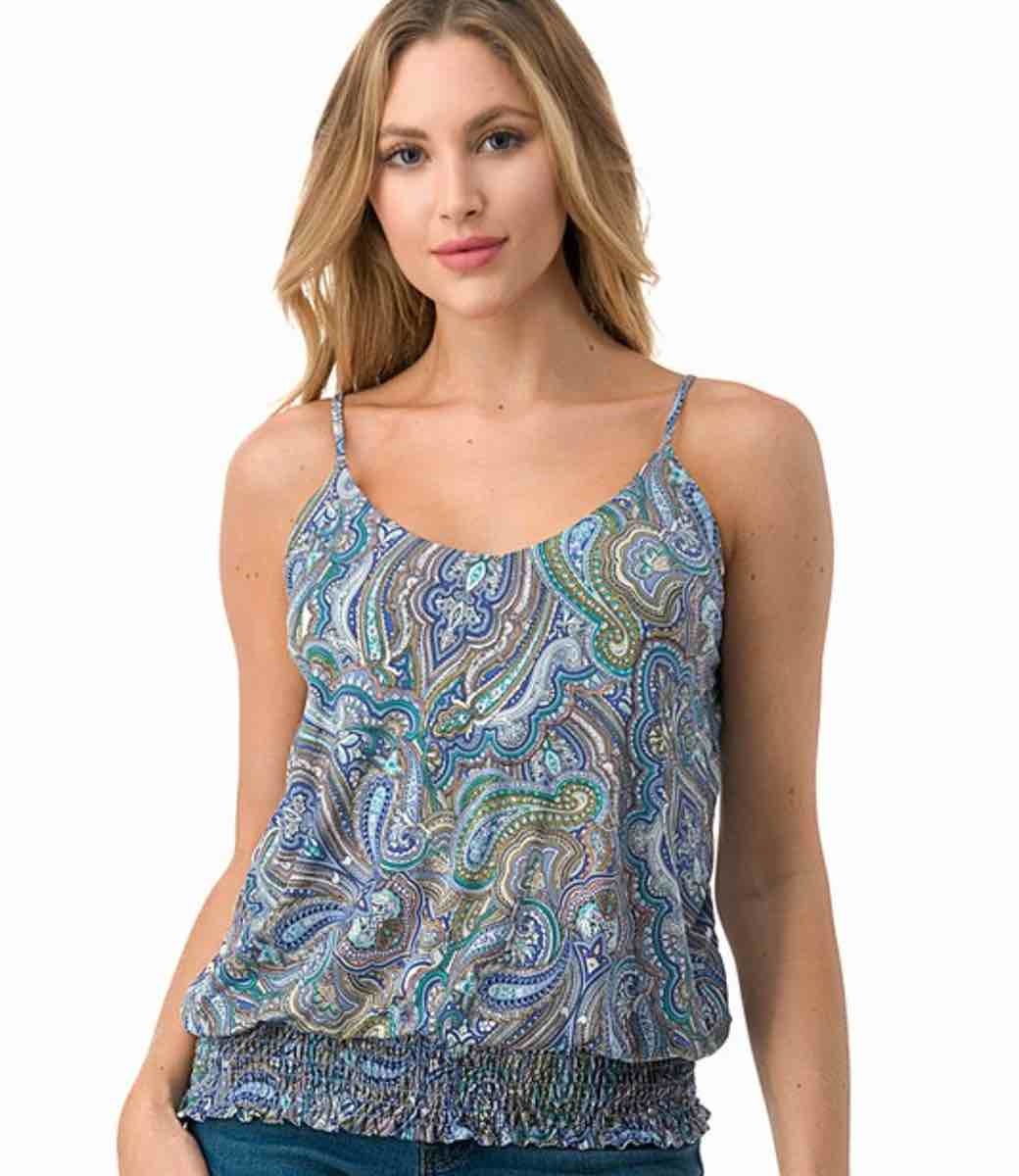 Woman wearing a relaxed-fit sleeveless tank top with a multi-colored blue and brown abstract paisley print.