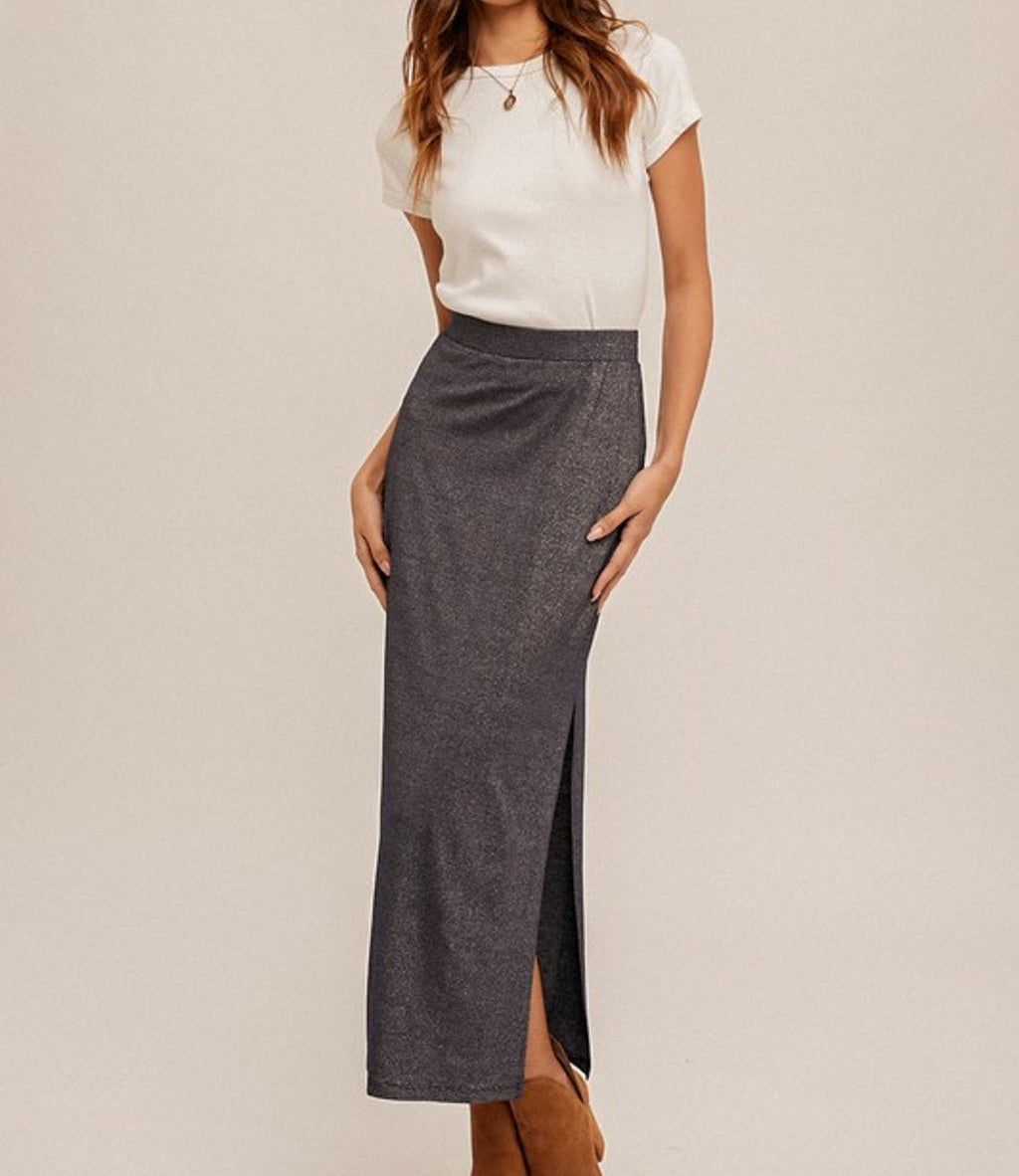 A navy blue jersey maxi skirt with a shimmering lurex finish and a side slit hem detail.