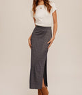 A navy blue jersey maxi skirt with a shimmering lurex finish and a side slit hem detail.