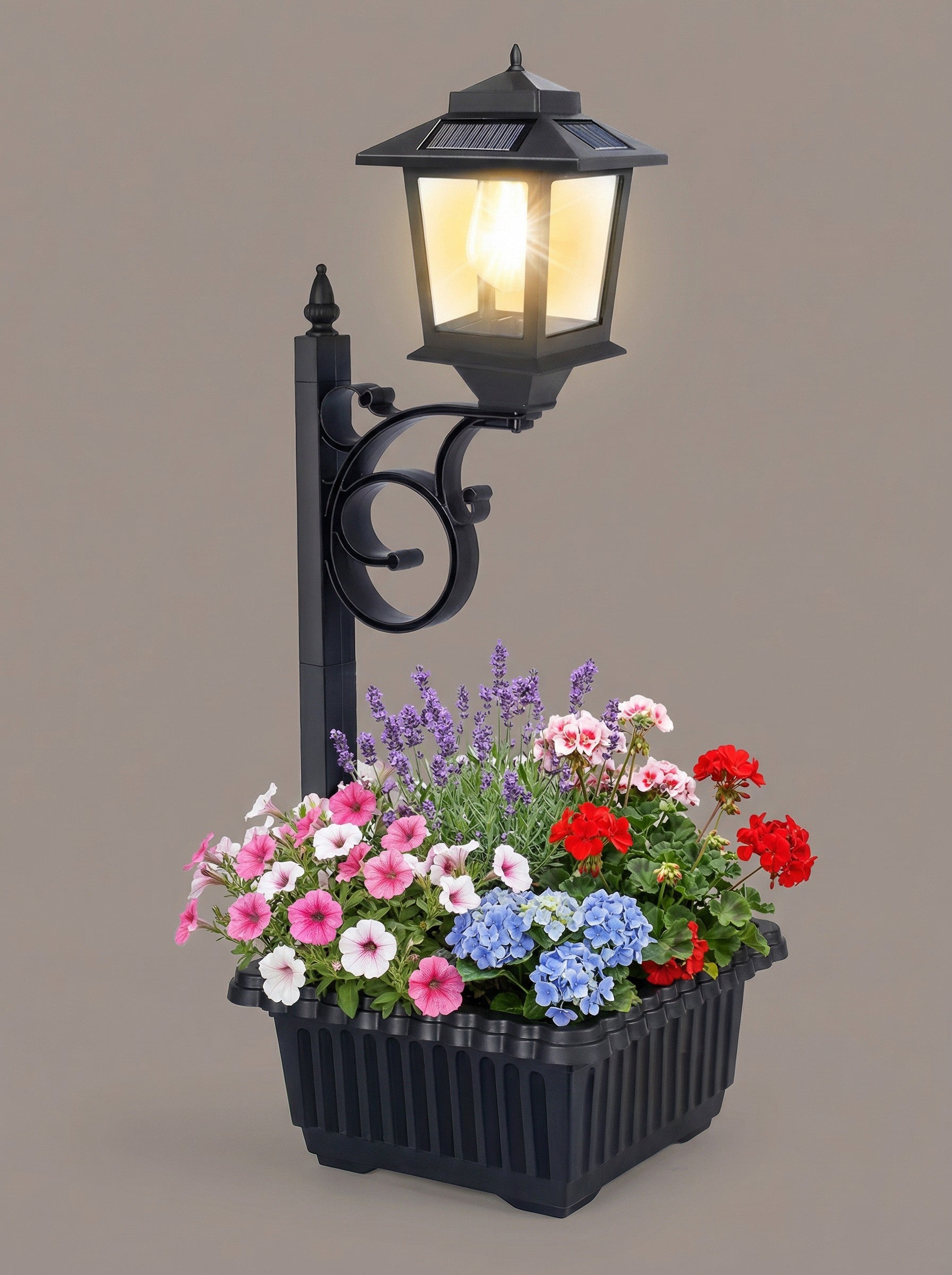 Matte black traditional solar lamp post with integrated flower pot in a lush garden setting