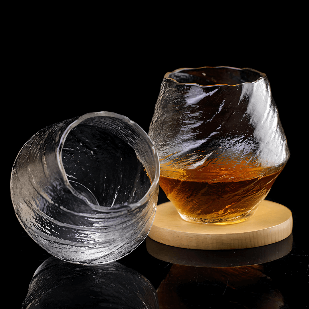 Set of Yume handcrafted textured clear crystal whisky glasses on a wooden coaster