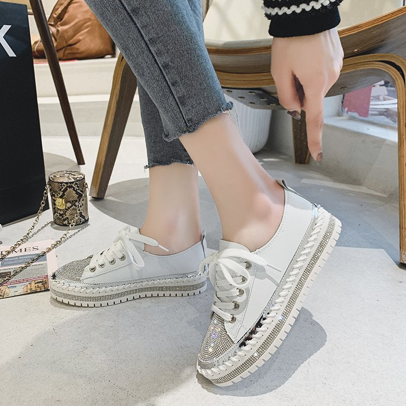 Close up of women's leopard print canvas sneakers with rhinestone embellishments and white lace-up closure.