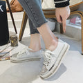 Close up of women's leopard print canvas sneakers with rhinestone embellishments and white lace-up closure.