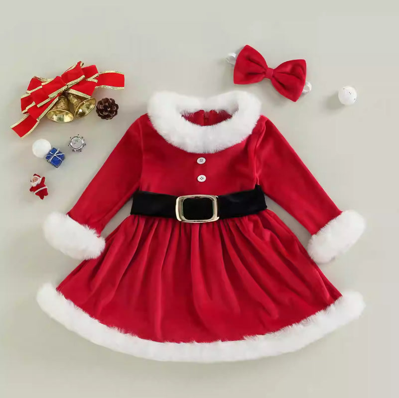 Baby girl wearing a red festive Christmas romper with sequins, ruffle sleeves, and a pleated tutu skirt.