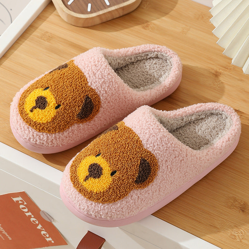 Plush knit slippers with smiley face pattern and soft fleece lining in multiple color options.
