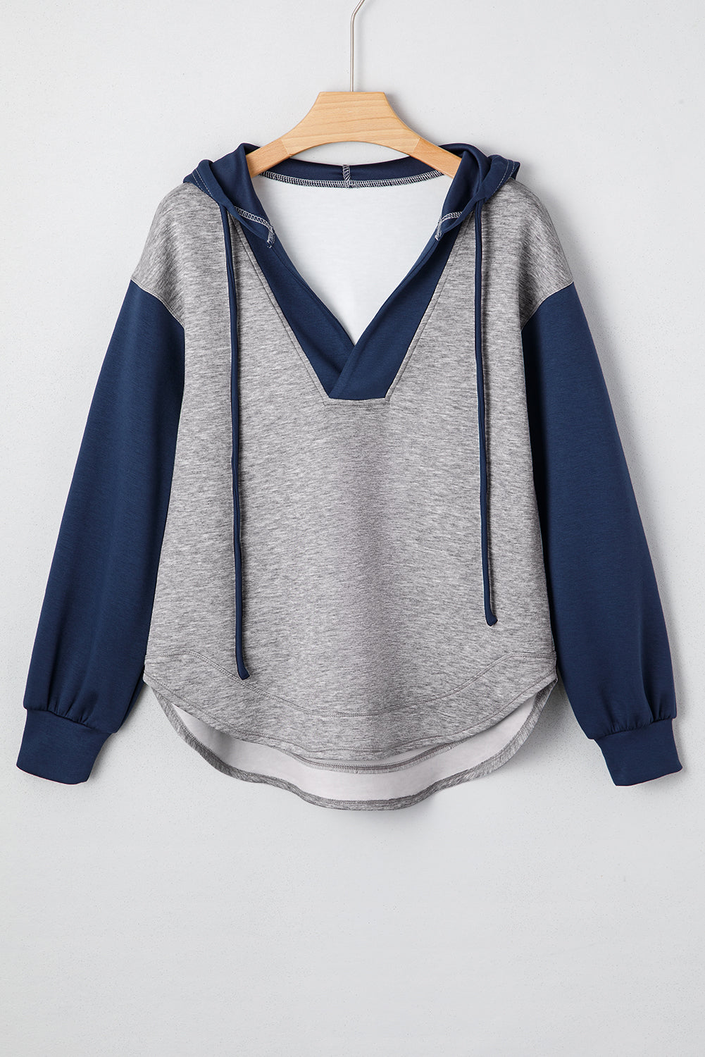 Front and back view of the Zariyah colorblock hoodie featuring gray body, navy sleeves, hood, and drawstring detail.