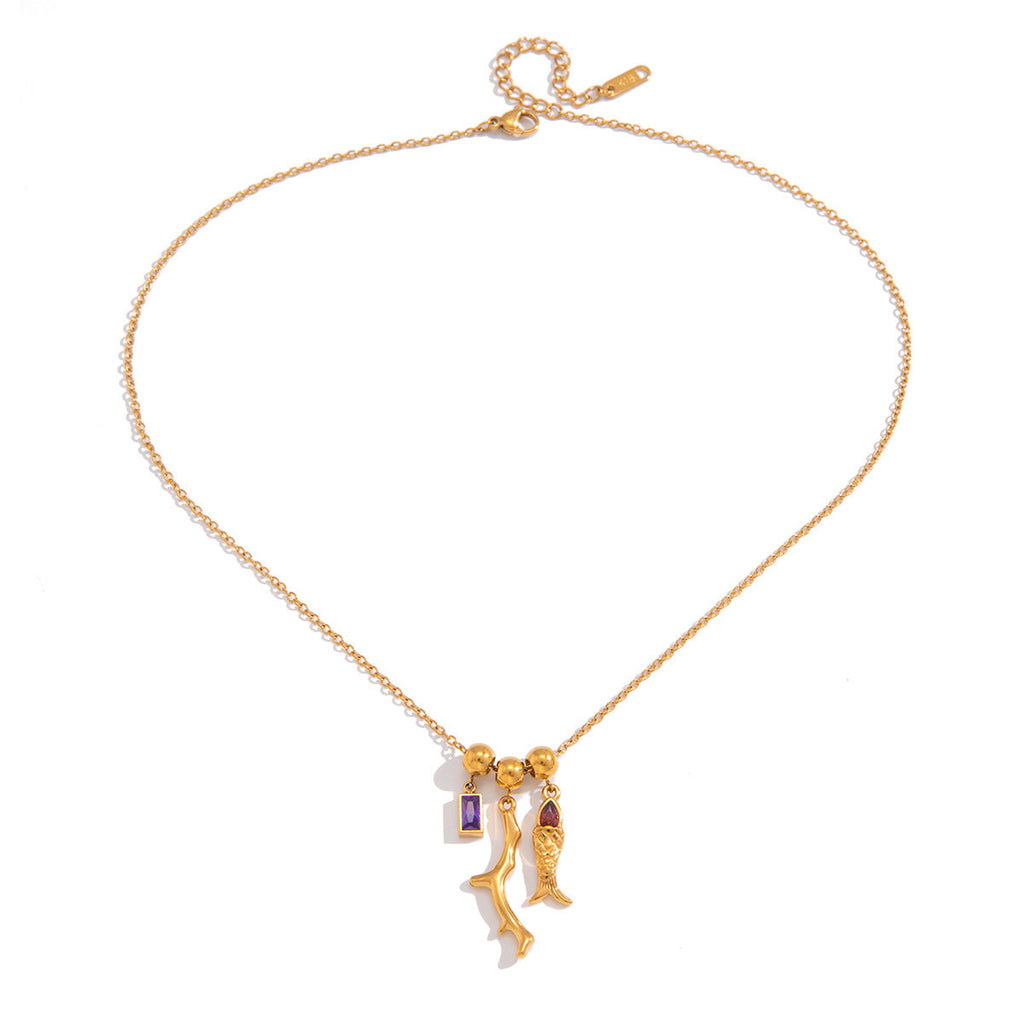 Gold fish pendant necklace with purple and red zircon accents.