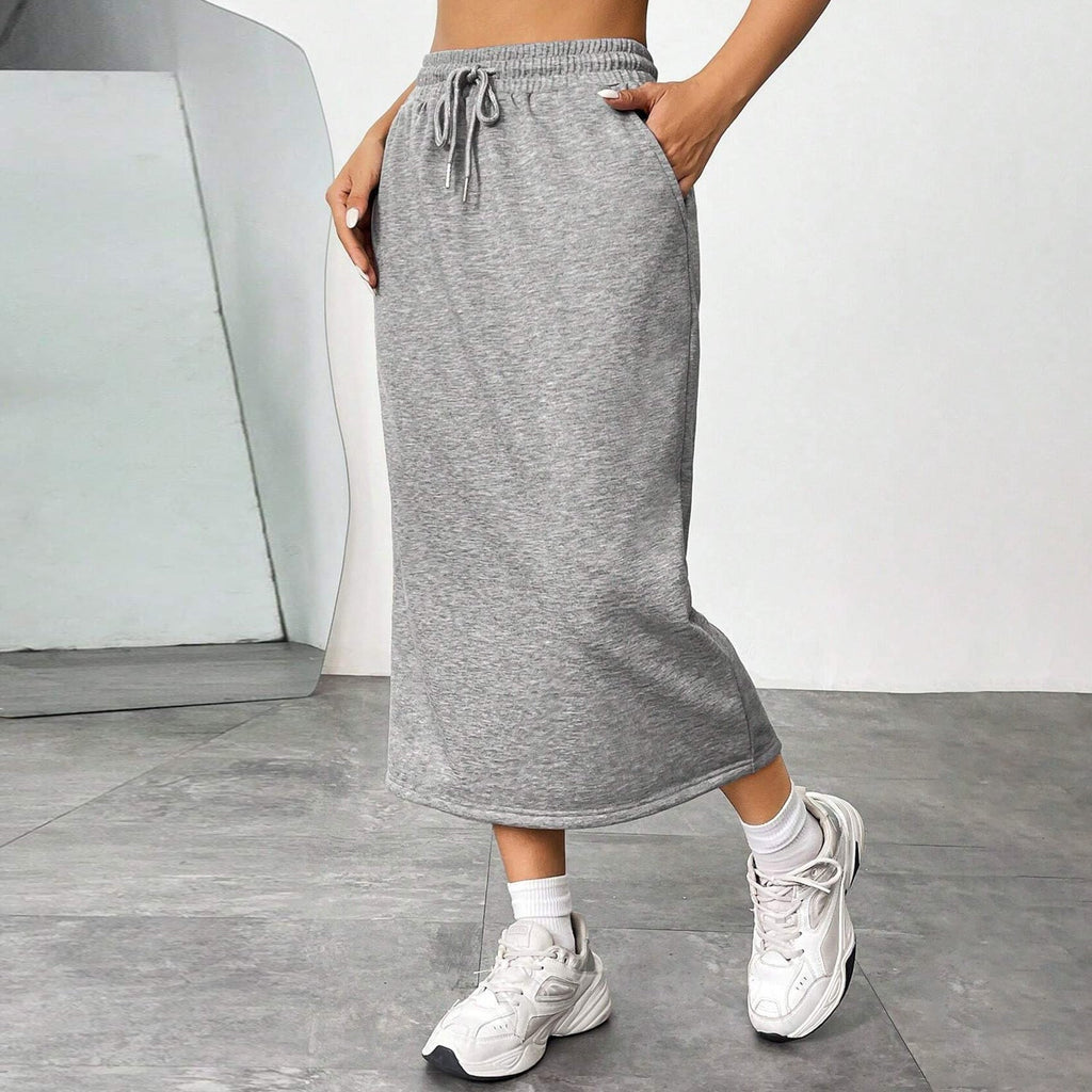 Woman wearing a loose-fit black elastic waist skirt in a commuter setting.