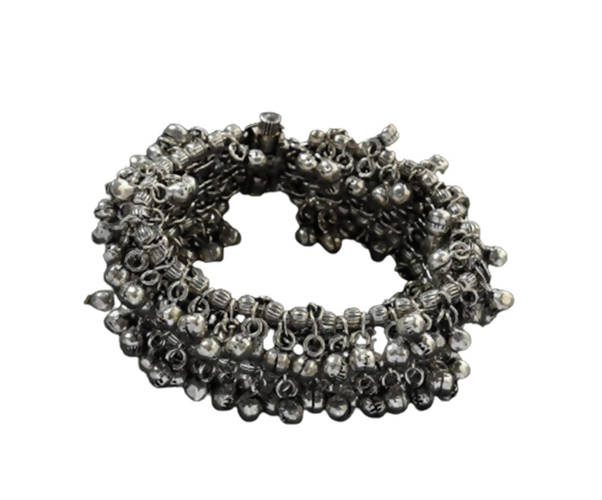 Close-up view of an oxidised silver-plated openable bracelet with hanging ghungroo beads