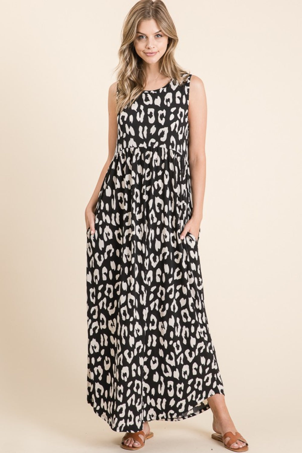 Woman wearing a leopard print maxi dress with a shirred waist and functional pockets