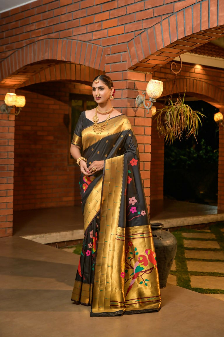 Elegant black Paithani silk saree with luxurious gold zari woven borders and matching blouse.