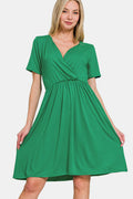 A solid green short sleeve dress with a surplice neckline.