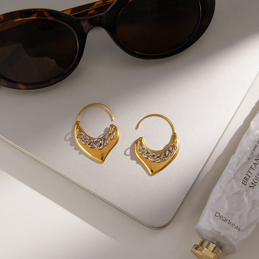A pair of lightweight 18K gold heart-shaped stud earrings with a polished finish