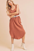 Midi length tank dress with round neckline and functional side pockets.
