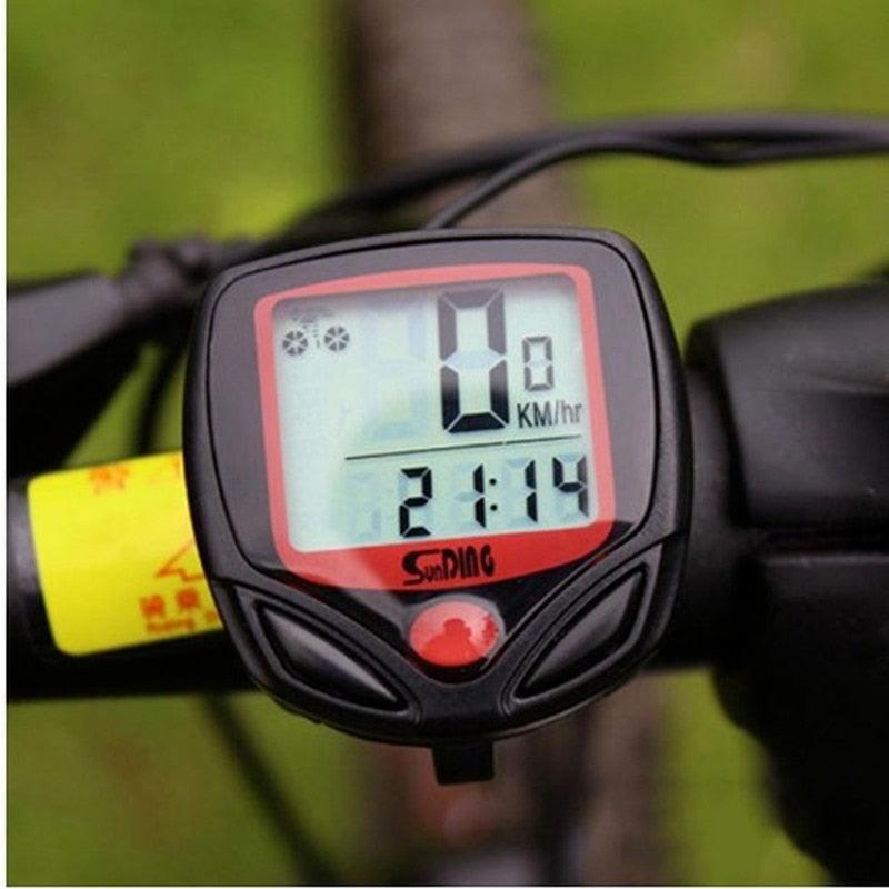 SunDing digital LCD bicycle computer and odometer in black and red, mounted on a handlebar