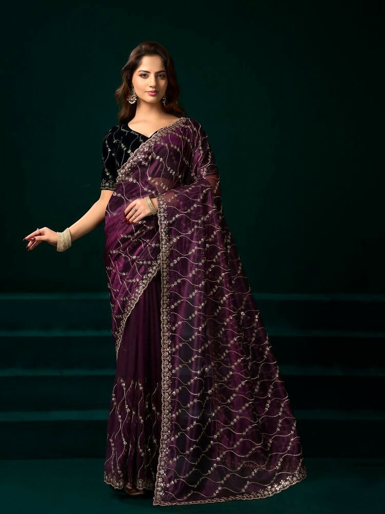 Wine colored net party wear saree with a black velvet blouse