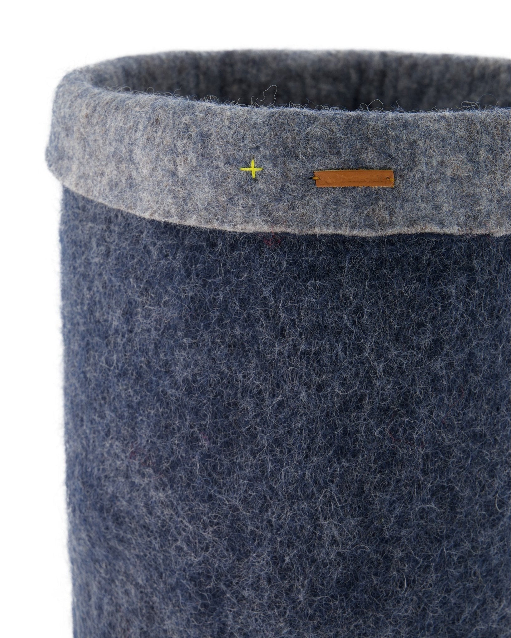 Blue felted storage basket with a gray rim on a white background