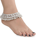 Close-up of a silver plated white metal traditional payal with a detailed matte finish.