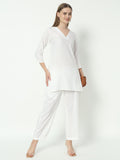 A woman wearing a white pure cotton V-neck co-ord set with a relaxed fit