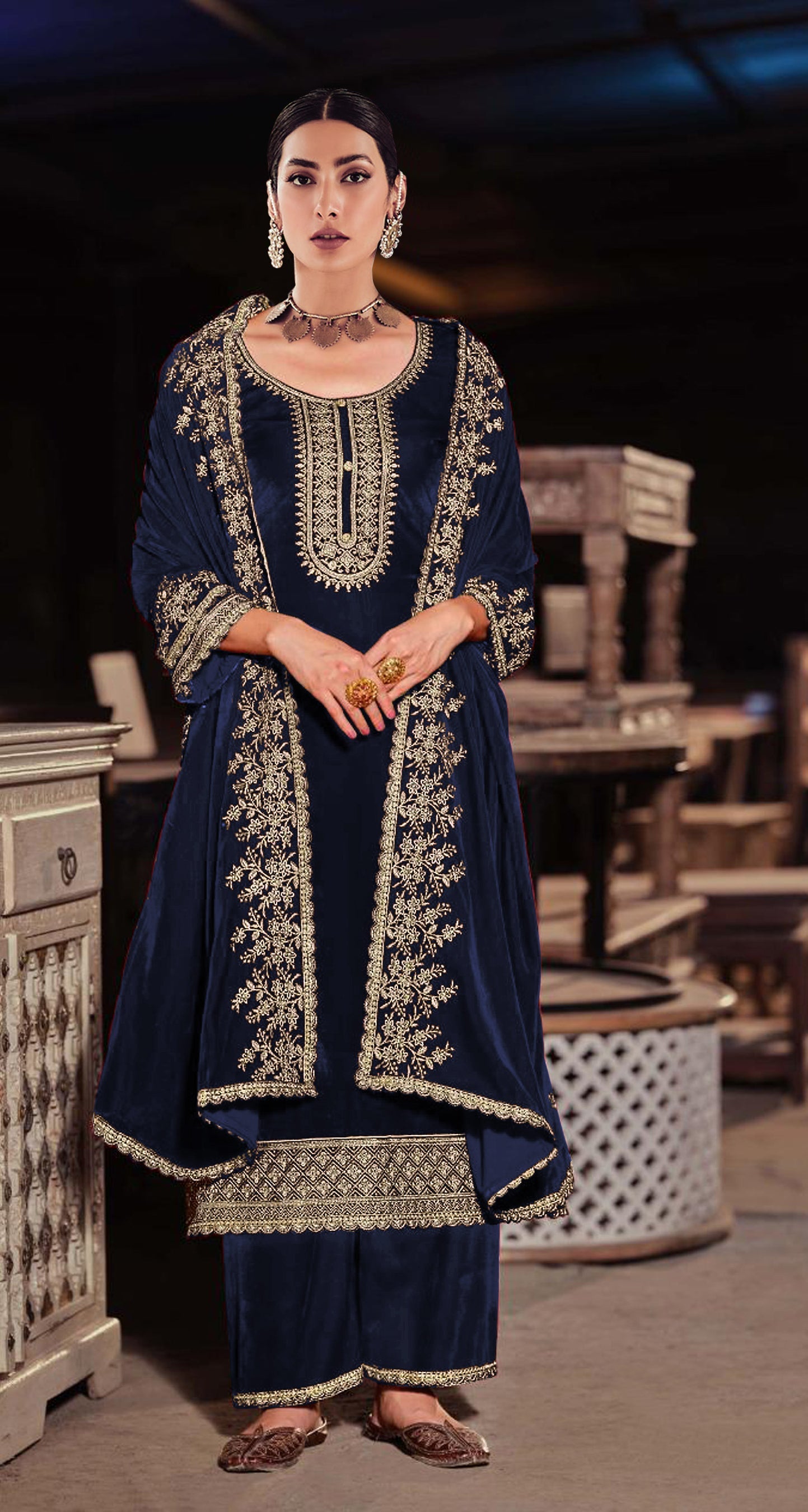 Close-up of premium blue velvet fabric with intricate sequence embroidery for salwar suit