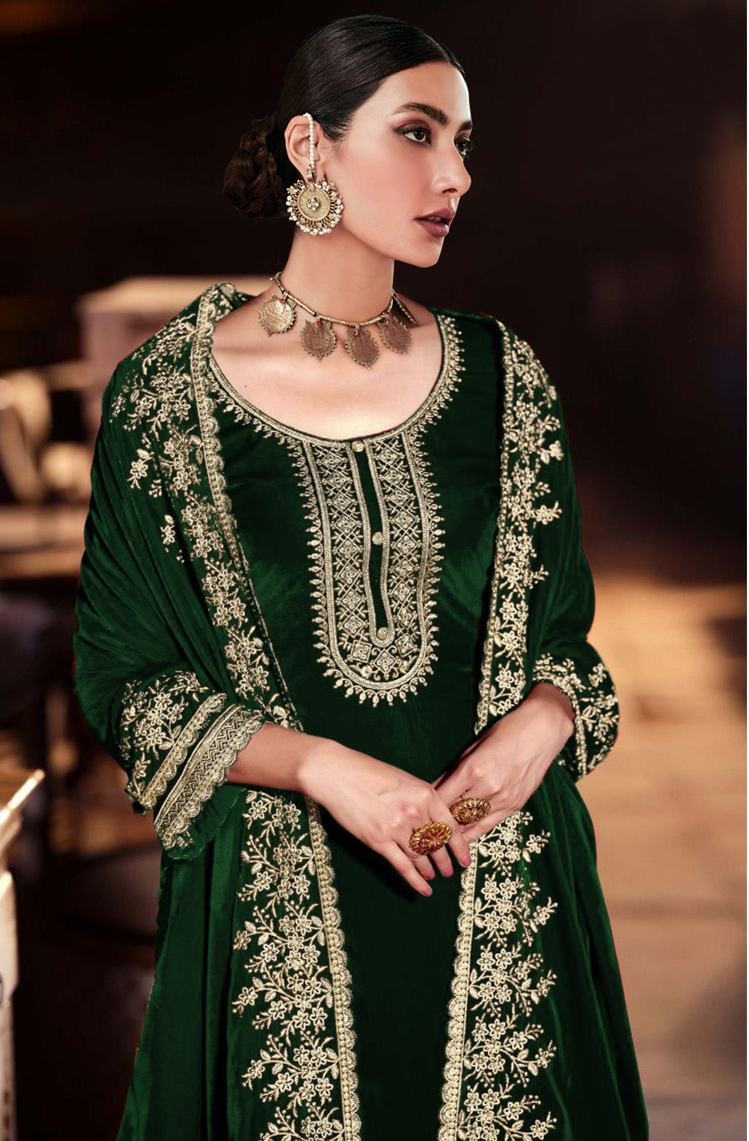 Unstitched green velvet dress material with intricate embroidery and sequence work