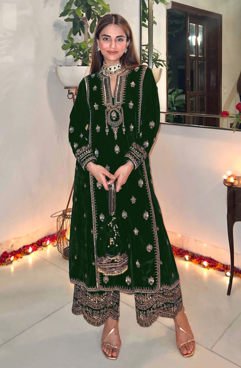 Close up of green velvet fabric with detailed embroidery and sequence work for a salwar suit
