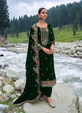 Close up of green velvet salwar suit fabric with intricate embroidery and sequence detailing