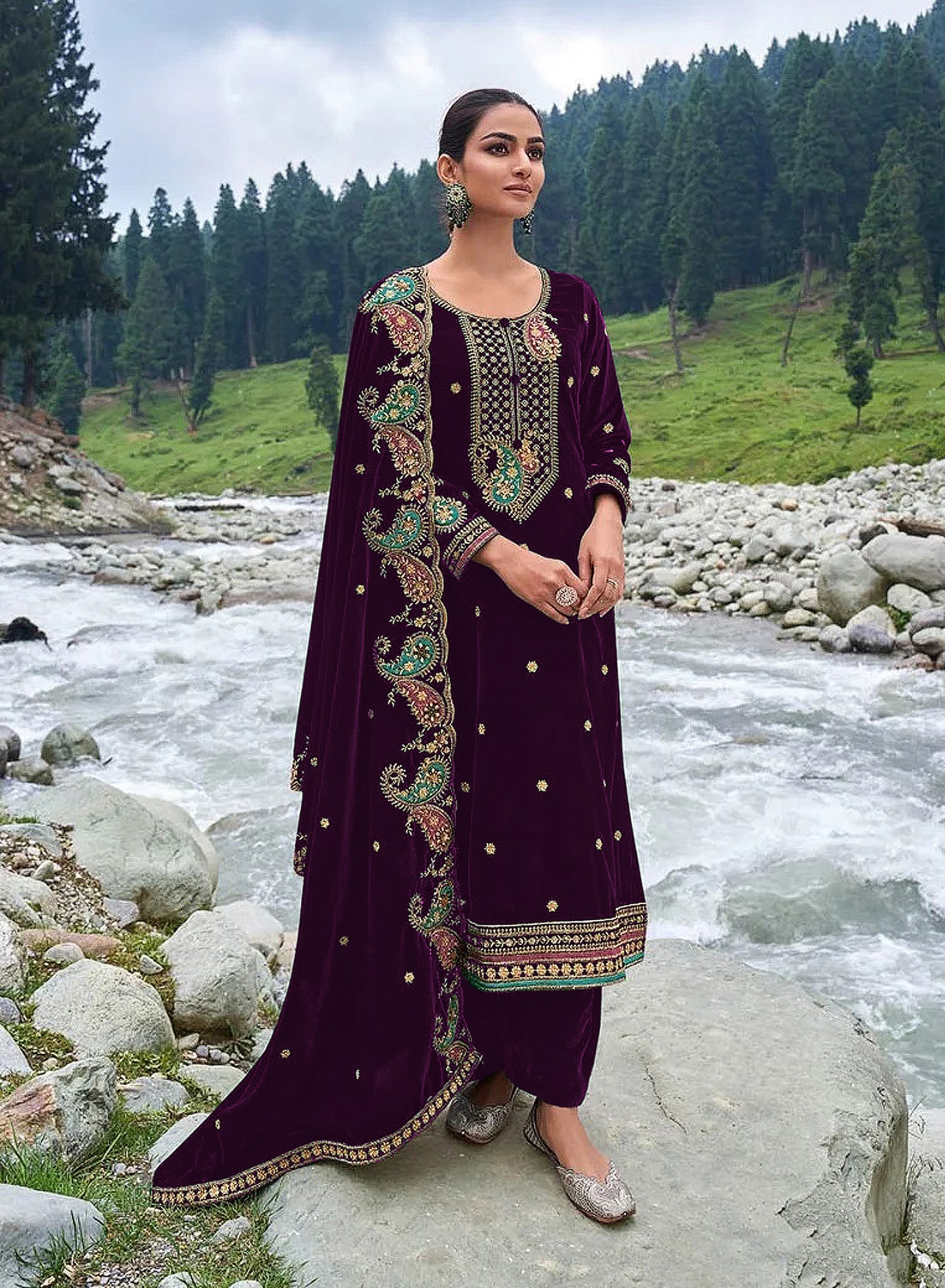 Detailed view of deep purple velvet fabric with elegant embroidery and sequences