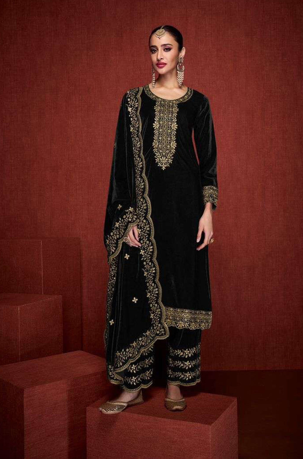 Detailed view of black velvet fabric with intricate embroidery and sequence detailing