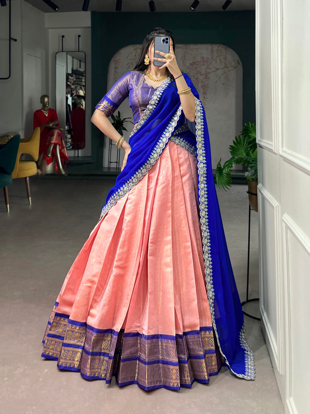 Elegant peach Kanchipuram lehenga choli featuring intricate zari weaving work and voluminous flair.